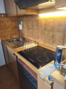 a kitchen with a stove with candles on it at Casa Bella Vista in Foppolo