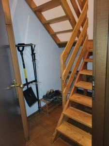 a wooden staircase in a room with shoes at Casa Bella Vista in Foppolo +9 photos
