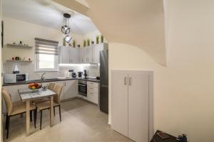 a kitchen with a small table and a refrigerator at Stellasrooms in Mytilene +7 photos
