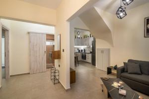 a living room with a couch and a table at Stellasrooms in Mytilene