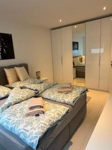 two beds sitting next to each other in a room at Beautiful living in Schönaich