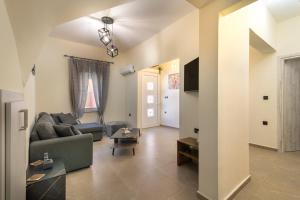 a living room with a couch and a tv at Stellasrooms in Mytilene