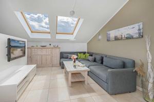 a living room with a couch and a table at Haus Ostseekristall Wohnung Rubin in Zinnowitz