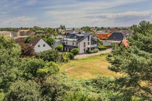 a group of houses on a hill with trees at Haus Ostseekristall Wohnung Rubin in Zinnowitz
