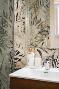 a bathroom with a sink and a mirror at Aroma Rooms Procida in Procida