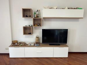 a white entertainment center with a flat screen tv on it at Little Venice in Sacile