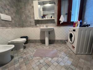 a bathroom with a toilet sink and a washing machine at Little Venice in Sacile +12 photos