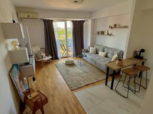 a living room with a couch and a table at City nest Skopje in Skopje