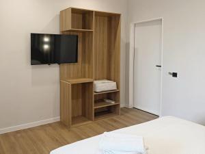 a room with a tv on a wall at Jetel Boutique Hotel in Almaty
