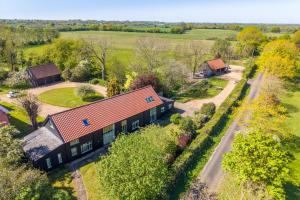 an overhead view of a house with a road next to it at Wolmers Barn in Stonham Aspall