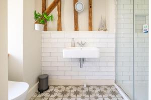 a bathroom with a sink and a shower at Wolmers Barn in Stonham Aspall +32 photos