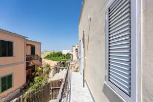 a view from the balcony of a building with a window at Aroma Rooms Procida in Procida