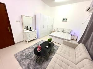 a living room with a couch and a table at المرور ابو ظبي in Abu Dhabi