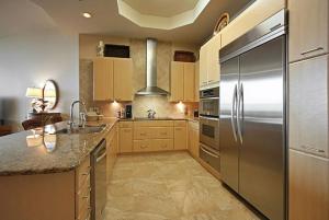a large kitchen with a stainless steel refrigerator at Caribe Resort Unit C101 in Orange Beach