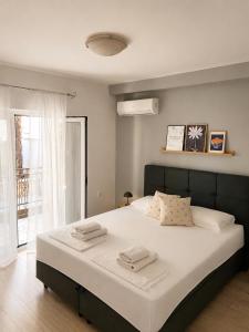 a bedroom with a large bed with two towels on it at Vila Marinessa in Hvar