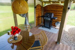 a patio with a table and a grill at Szyszkowy Domek in Milejczyce