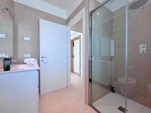 a bathroom with a glass shower and a sink at Hotel Royal Garnì in Caorle +90 photos