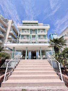 a large building with stairs in front of it at Hotel Royal Garnì in Caorle