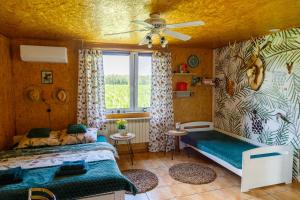 a bedroom with a bed and a window at Szyszkowy Domek in Milejczyce