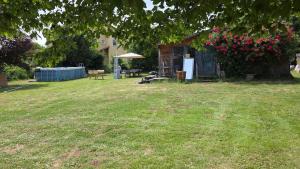 a yard with a house with a yard at Le Dômes du Ceyssoux in Le Brignon