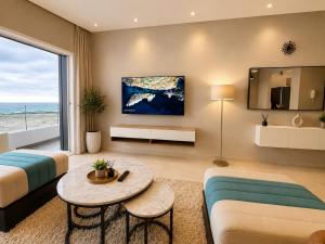 a living room with a couch and a table at Ocean Therapy in Dar Oulad Hajj Kassem