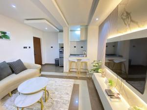 a living room with a couch and a table at The Royal Enclave in Abuja +4 photos