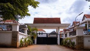 a black gate of a house with a driveway at The Royal Enclave in Abuja