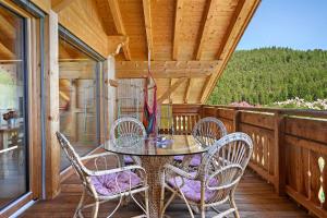 a patio with a table and chairs on a porch at Schwabl Auf Der Ebene in Meltina