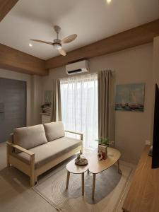 a living room with a couch and a table at J-Stays 2BR Beach Condo at Seafront Residences in San Juan