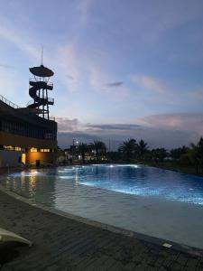 a large swimming pool in front of a building at J-Stays 2BR Beach Condo at Seafront Residences in San Juan