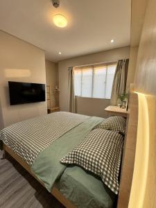 a bedroom with a bed and a television in it at J-Stays 2BR Beach Condo at Seafront Residences in San Juan +38 photos