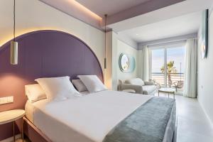 a hotel room with a bed and a view of the ocean at Blue Malva in Valencia