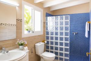 a bathroom with a toilet and a sink and a shower at Villa Roca Nova in Cacla D'or +11 photos