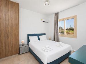 a bedroom with a white bed and a window at Villa Diana Seaside in Pomos +21 photos