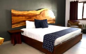 a bedroom with a large bed with a wooden headboard at Samanu Hotel & Suites in Sayulita +24 photos