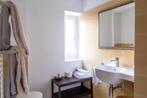 a bathroom with a sink and a toilet and a mirror at Hotel Il Castagno in Mugena +107 photos