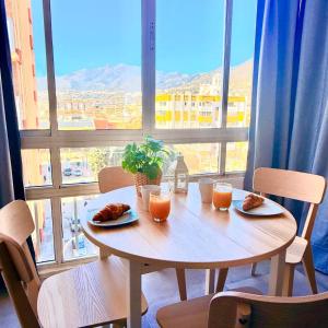 a table with two plates of food and two glasses of orange juice at Hercules in Arroyo de la Miel