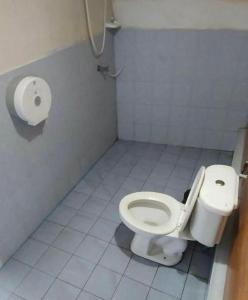 a bathroom with a toilet and a toilet paper dispenser at OK Bungalow in Ko Tao +47 photos