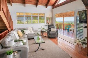 a living room with a couch and a table at New Mountain Escape Panoramic San Juan Views in Aguas Buenas