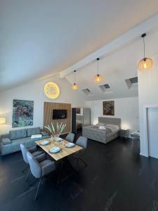 a living room with a table and a couch at Erdeis Apartments in Krems an der Donau