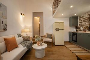a living room with a couch and a kitchen at Lithoskino Suites in Batsi