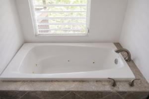 a bath tub in a bathroom with a window at New Mountain Escape Panoramic San Juan Views in Aguas Buenas +22 photos