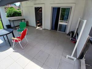 a patio with two chairs and a table and a table at cabañas cosquin in La Porteña