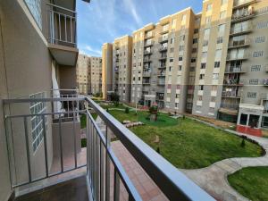 an apartment balcony with a view of a park at Acogedor Refugio en Tacna in Tacna
