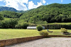 a field of grass with a mountain in the background at Casa Aria Pura in Alano di Piave
