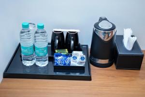 a tray with two bottles of water and a blender at Star Light Suites in Bangalore