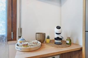 a table with a coffee maker and cups on it at Casa Aria Pura in Alano di Piave