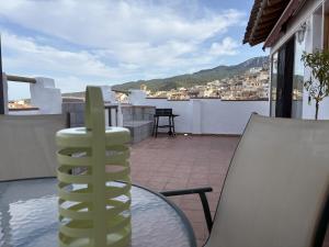 a balcony with a glass table and a swimming pool at El Redoble de Moratalla in Moratalla