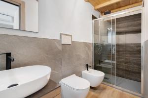 a bathroom with a sink and a toilet and a shower at Casa Aria Pura in Alano di Piave +37 photos