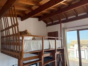 a bedroom with a bunk bed and a balcony at El Redoble de Moratalla in Moratalla